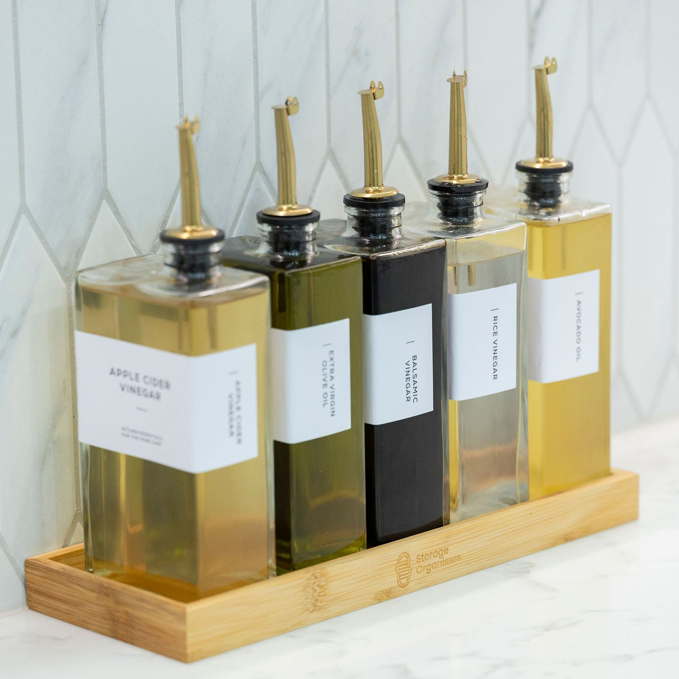 Five glass oil and vinegar bottles with bamboo storage tray
