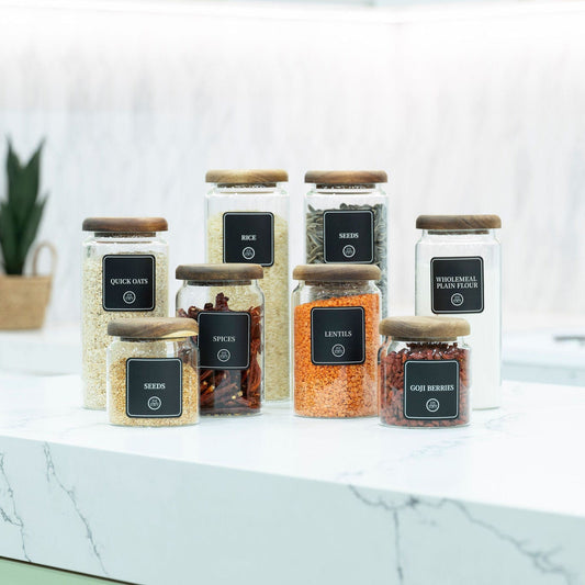 Selection of acacia wood lid glass pantry jars showing the different sizes available in the set